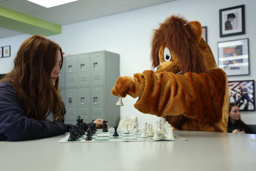 Jilll Wilson, 10th grade, engaged in an exciting game of chess with Judah the Lion.
