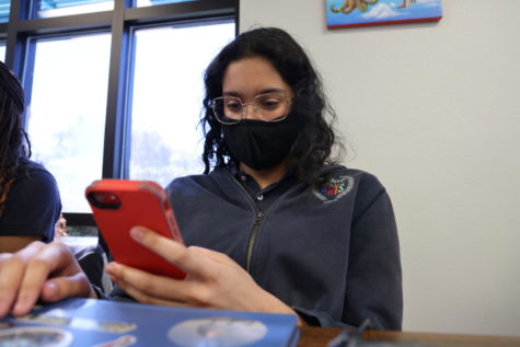 Jaylen Velez, 11th grade, checks a phone notification from her FLVS teacher during study hall