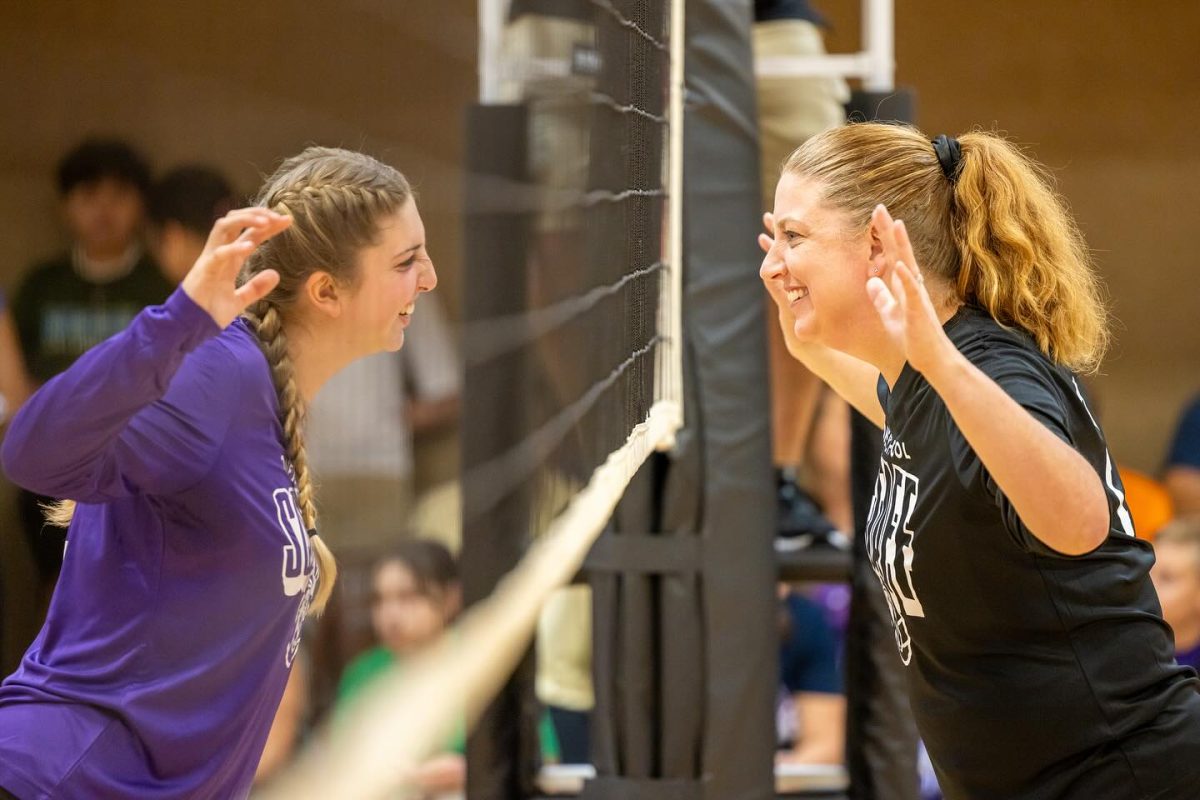 Kristi+Combs+and+Carli+Combs+face+off+against+each+other+at+the+staff+versus+scholar+volleyball+game.+
