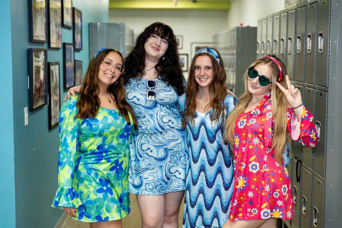 Emma Vega, Ashlyn Caldwell, Allie Thomas, Aubrey Gibson dressed like the 70s for decade day. 