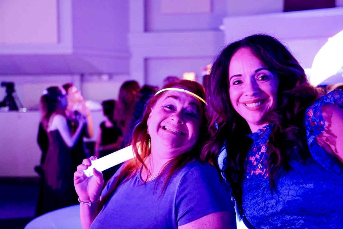 Joan Torres and Diane Downer, staff, join in the glow theme as the 2024 Homecoming Dance kicked off. 