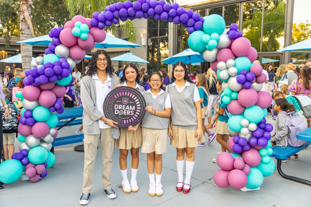 Welcome back Dream Doers! Melody, Moses, Genesis, and Joy Chavez pose under the back to school arch to kick off a new school year. 