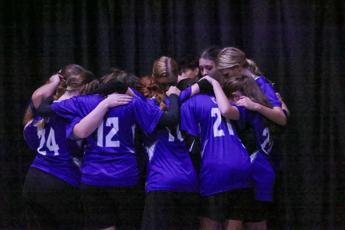 The Lion's Varsity team pray before starting the game against Space Coast. 