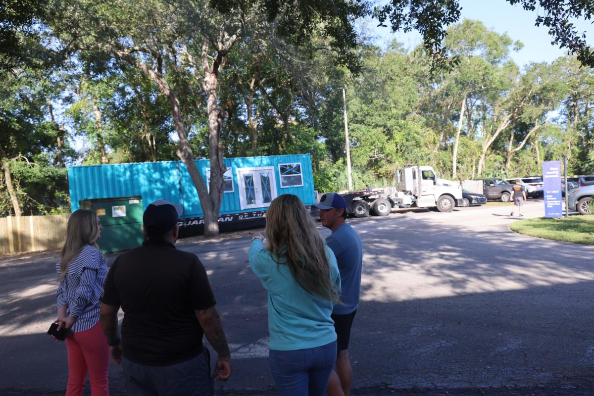 As the uniform store container arrives on campus, Mrs. Sayavan tells them where it should be set up. 