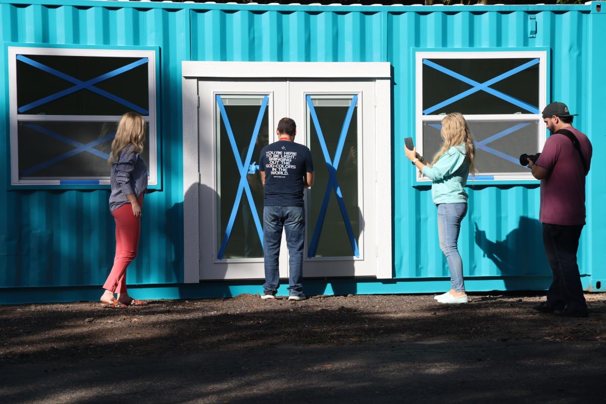 Mr. Febres gets to open the door to see his new space for the uniform store container. 