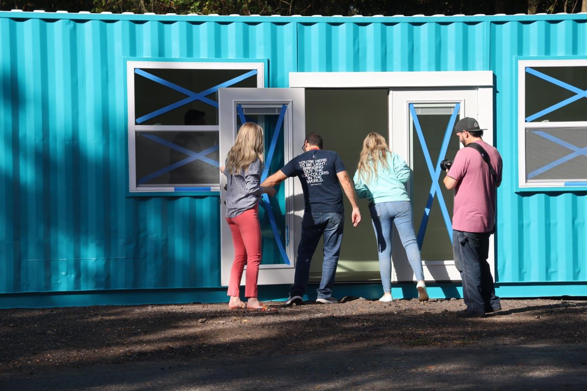 The team checks out the inside of the new uniform store space as it is delivered. 