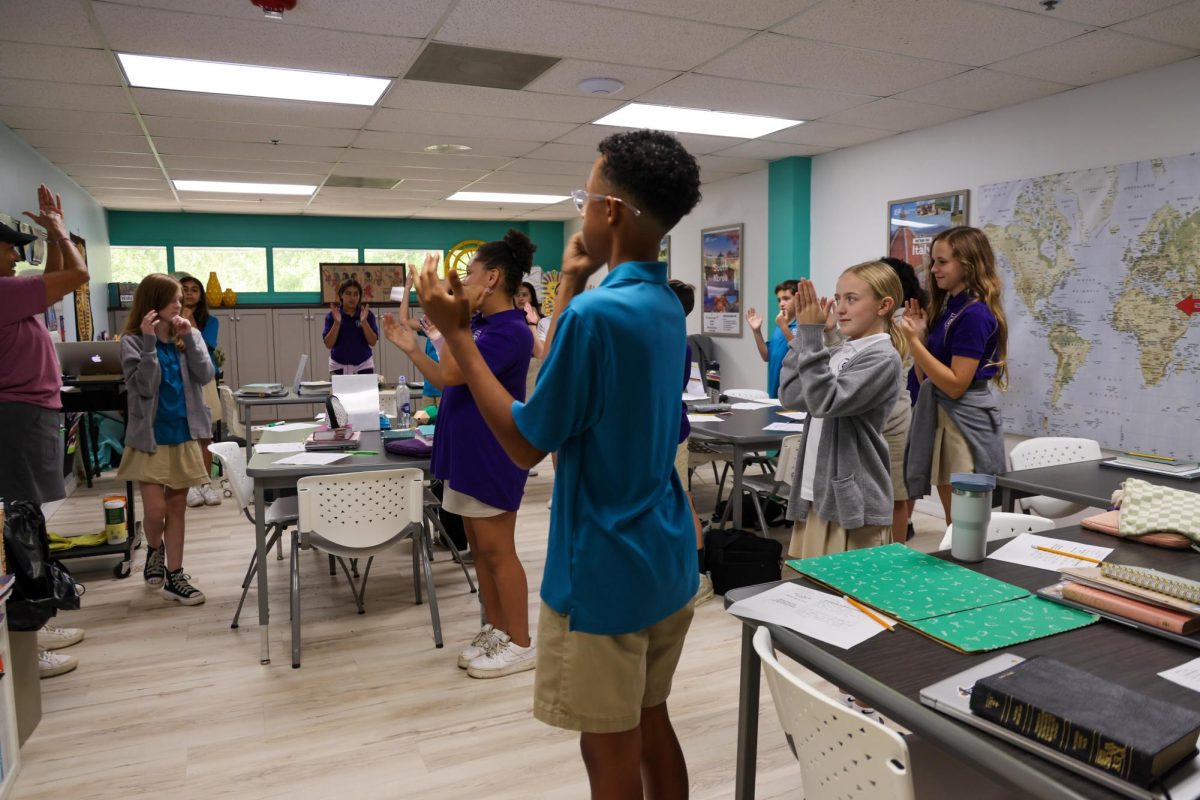 Learning with motions, Mrs. Schreiner's 6th grade Bible class learned about Martin Luther's Protestant Reformation. She taught them a hands on song to remember the facts of the event. 