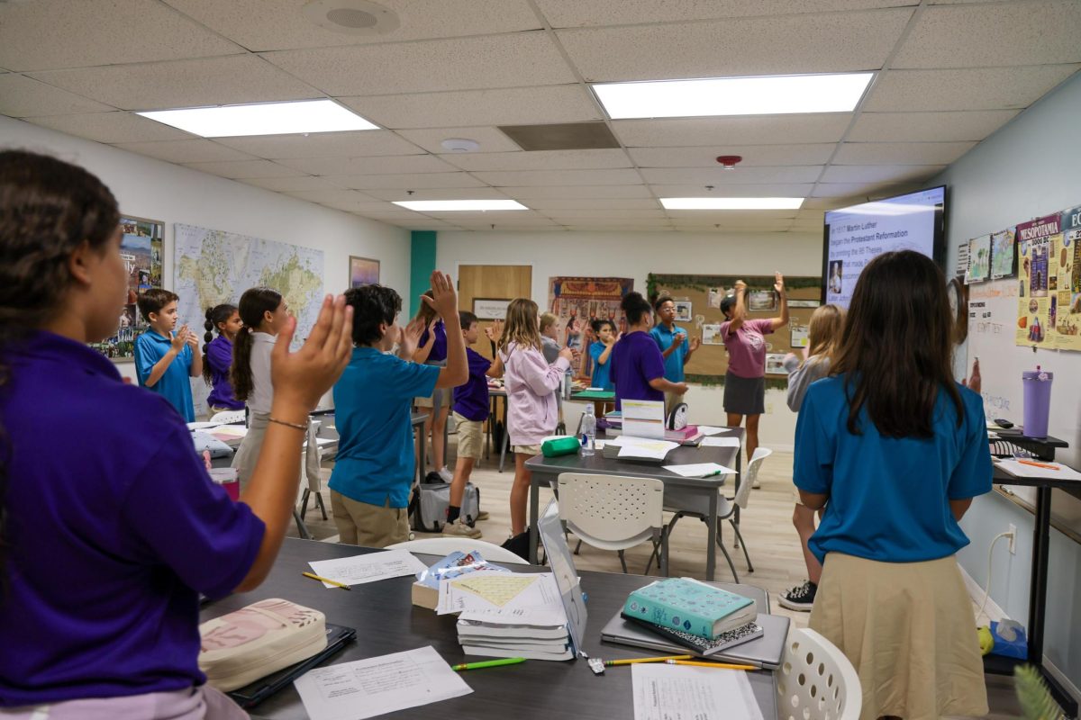 Learning with motions, Mrs. Schreiner's 6th grade Bible class learned about Martin Luther's Protestant Reformation. She taught them a hands on song to remember the facts of the event. 