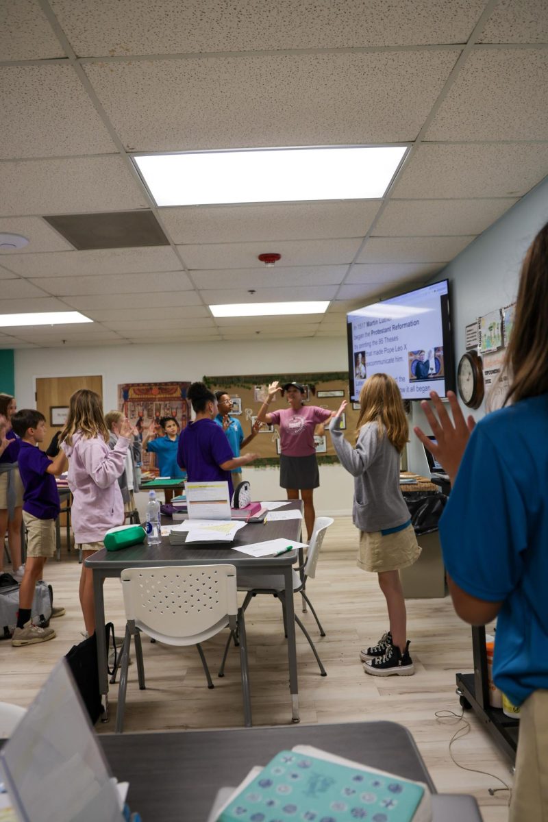 Learning with motions, Mrs. Schreiner's 6th grade Bible class learned about Martin Luther's Protestant Reformation. She taught them a hands on song to remember the facts of the event. 