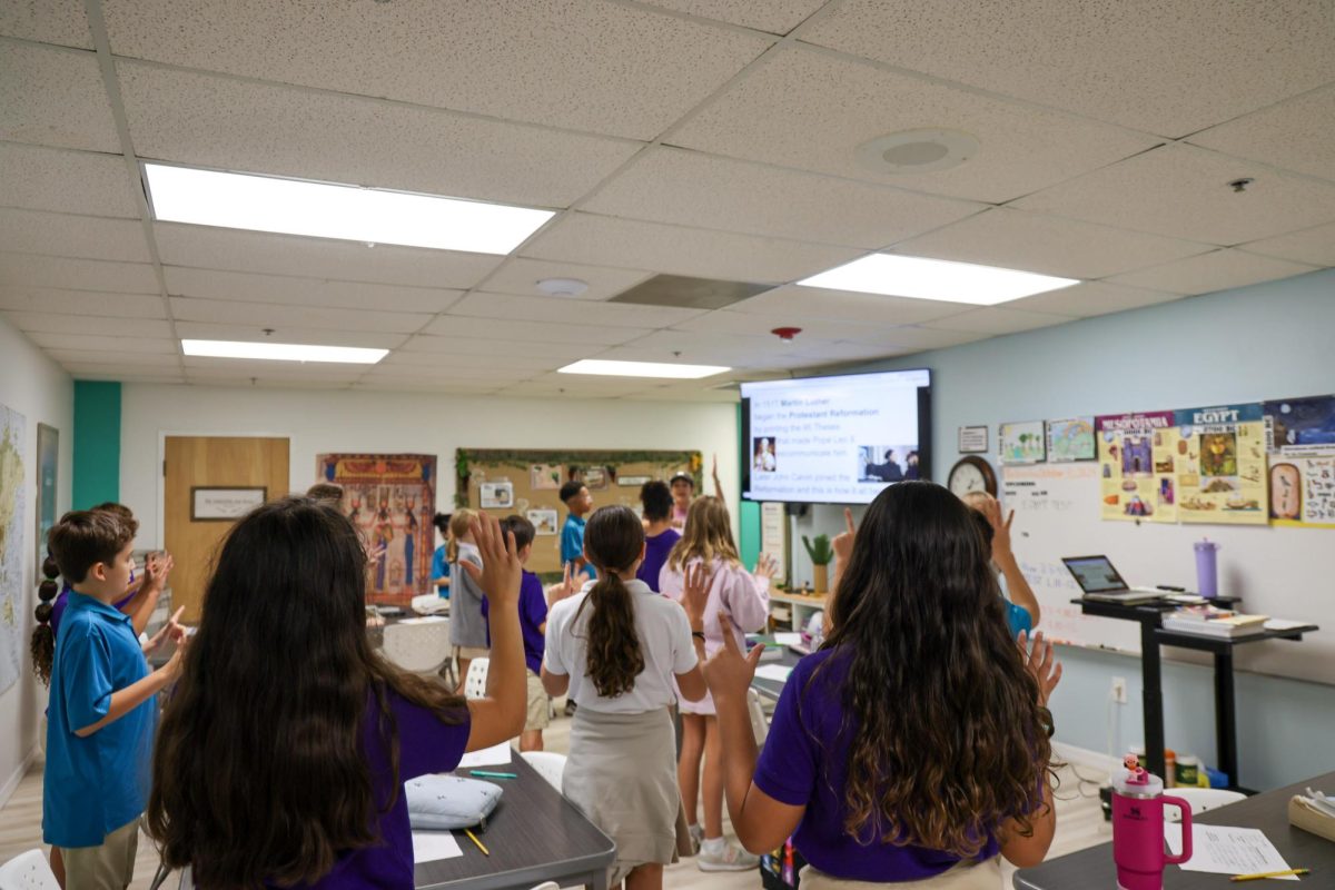 Learning with motions, Mrs. Schreiner's 6th grade Bible class learned about Martin Luther's Protestant Reformation. She taught them a hands on song to remember the facts of the event. 