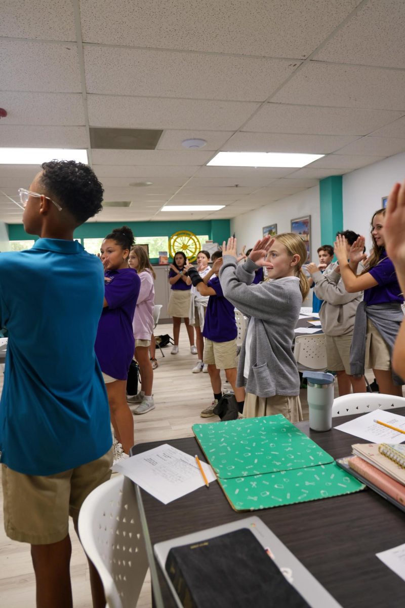 Learning with motions, Mrs. Schreiner's 6th grade Bible class learned about Martin Luther's Protestant Reformation. She taught them a hands on song to remember the facts of the event. 