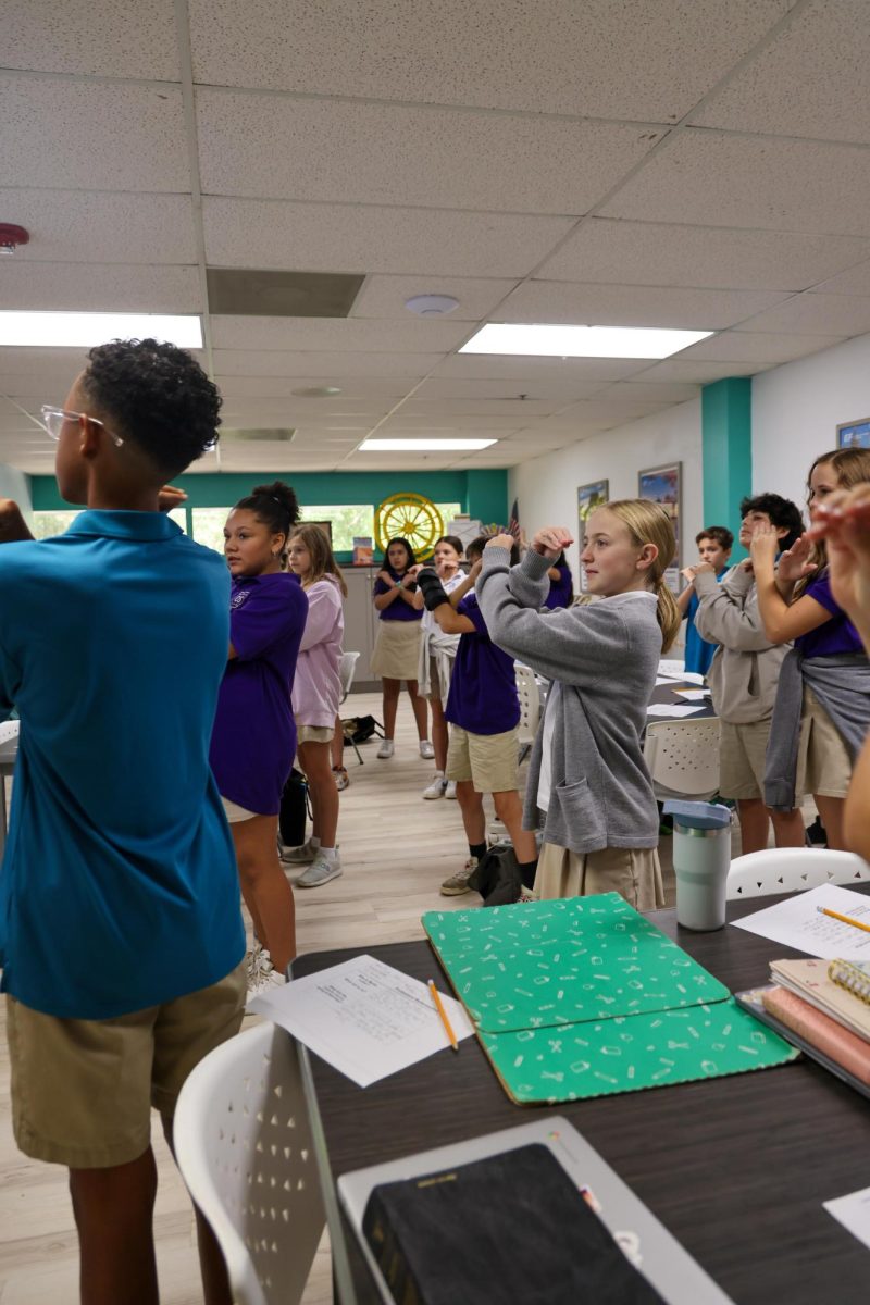 Learning with motions, Mrs. Schreiner's 6th grade Bible class learned about Martin Luther's Protestant Reformation. She taught them a hands on song to remember the facts of the event. 