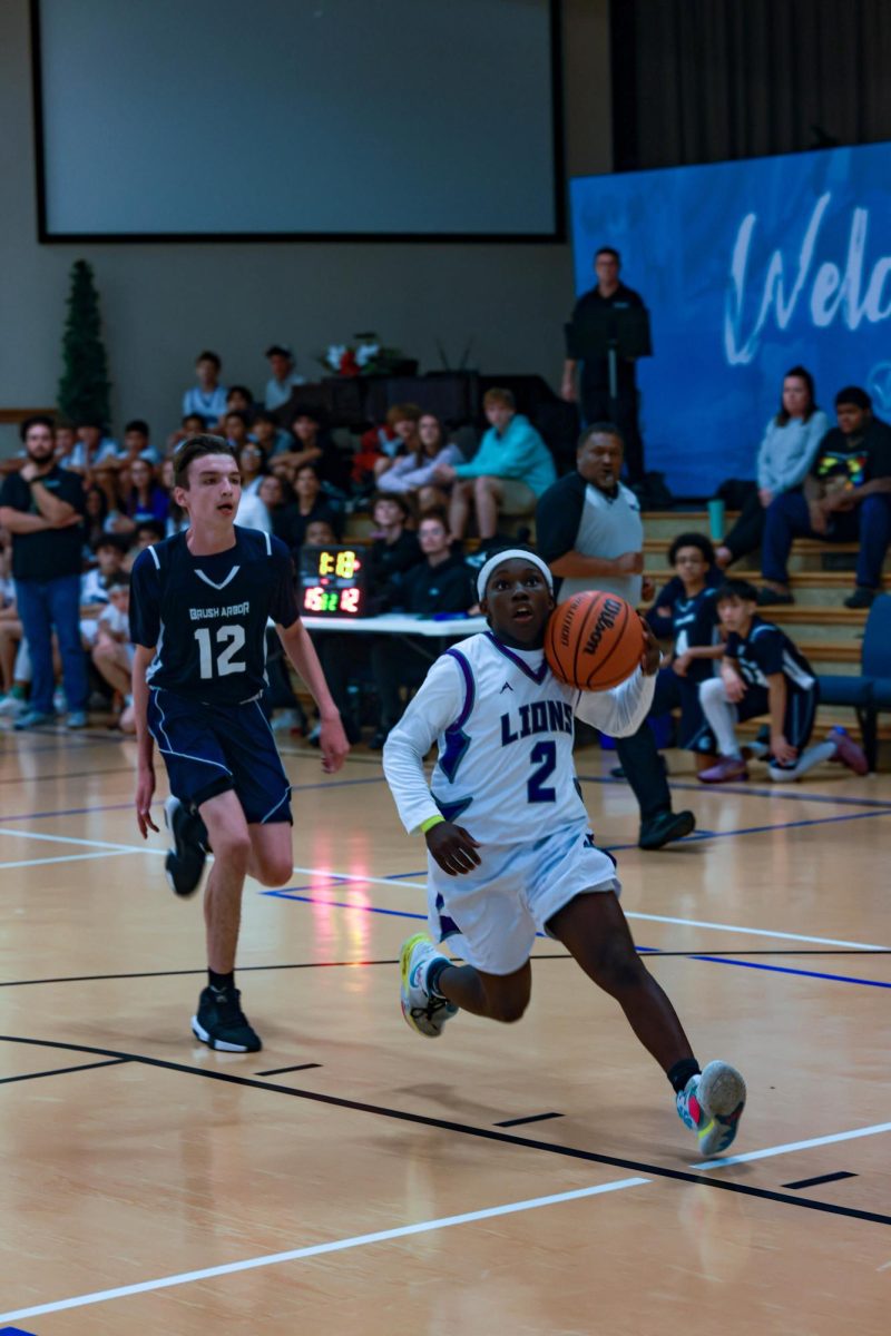 Ethan Prendergast, 10th grade, evades his defender on the way to the basket. 