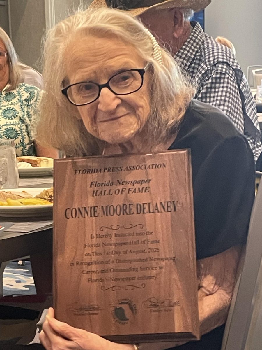 Connie Delaney holding her plaque after being the 2025 inductee into the Florida Press Association Hall of Fame over the summer. 