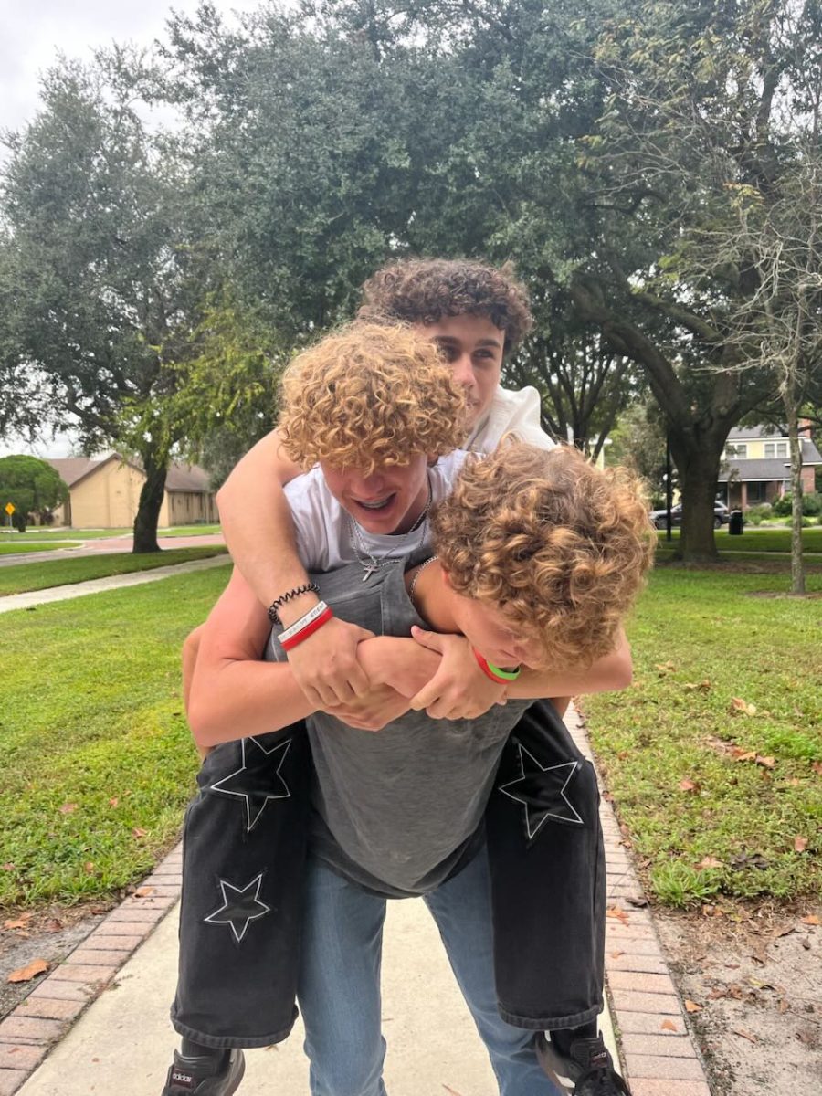 During some down time on the senior photo day, Jeremiah Schilling, Caden Tucker, and Zadiel Vientos, play around. "We were trying to make a totem pole," said Tucker. 